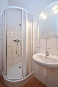 a bathroom with a shower and a sink at Apartmány Marie a Tereza in Benešov nad Černou
