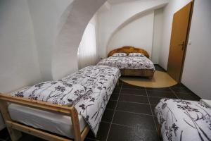 two beds in a small room with an attic at Hostel - Rooms Kaj & Kaja in Orehova vas 