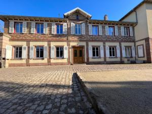 a large building with a brick driveway in front of it at Villa Avril Gîte Privé Luxe 15 pers- deux piscines intérieure, extérieure-sauna -proche Europapark in Sélestat