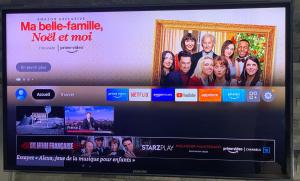 a television screen with a picture of a family at Apartments Monaco in Monte Carlo