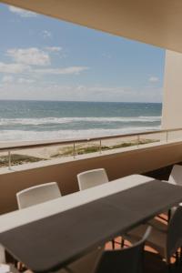 a table and chairs with a view of the ocean at Lescalier Cabanas 511 in Amanzimtoti