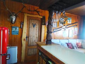 a room with wood paneled walls and a room with a couch at Apartamento De Lujo En Sierra Nevada in Sierra Nevada