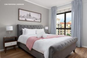 a bedroom with a large bed with a large window at Century City Boutique Apartments in Cape Town +100 photos