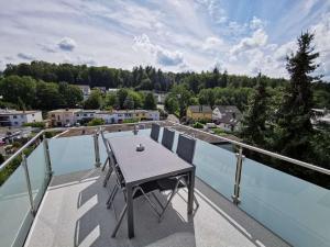 a balcony with a table and a view of a city at Apartments Waldbronn in Waldbronn