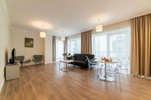 a living room with a couch and a table at Platinum Towers Central Apartments in Warsaw