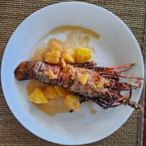 a white plate with some food on a table at Eastwind Beach Club- El Nido in El Nido
