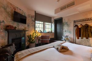 a bedroom with a bed and a fireplace at The Wolfpack Inn in London