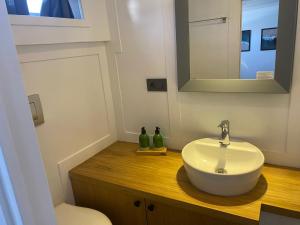 a bathroom with a white sink and a mirror at Yacht Room Hotel in Fethiye