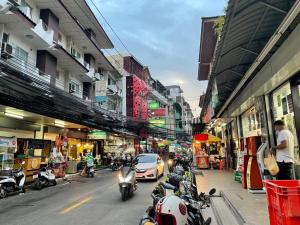 a city street with motorcycles parked on the side of the road at The Neuf@Ratchada in Bangkok