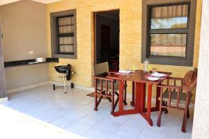 a dining room with a table and some chairs at Tlou Safari Lodge in Kasane