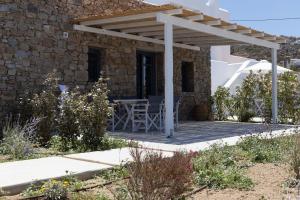 a patio of a house with a wooden pergola at Archon Seaside Retreat in Plaka