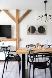 a dining room with a wooden table and chairs at Apartament Onyks in Zakopane