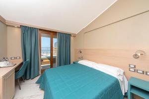 Postel nebo postele na pokoji v ubytování Hotel Porto Roca