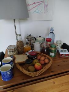 a table with a basket of fruit and other food at Offa Hideaway in Leamington Spa +10 photos