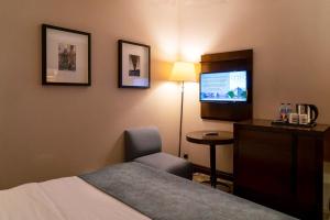 a hotel room with a television and a bed at Midtown Hotel in Istanbul