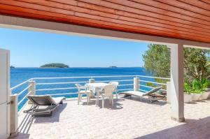 a patio with a table and chairs and the ocean at Apartmani Srdjana in Prizba