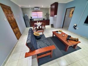 a living room with a couch and a table at Tlou Safari Lodge in Kasane
