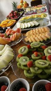 a table filled with different types of fruit on plates at miKasa Agua Amarga & SPA in Agua Amarga