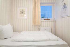 Ein Bett oder Betten in einem Zimmer der Unterkunft Ferienwohnung Luxus mit Wattenmeerblick