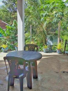 a table and two chairs and a table and a table and chairs at Rithu Homestay in Sigiriya