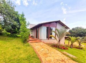 a house with a stone walkway leading up to it at Pousada Villa Magna - Casa 4 in Diamantina