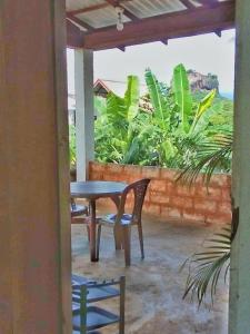 a patio with a table and chairs on a balcony at Rithu Homestay in Sigiriya
