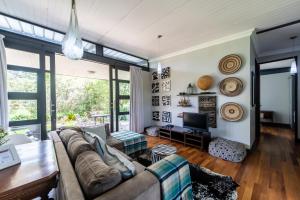 a living room with a couch and a tv at Wolf Unit in Pretoria