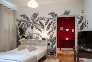 a bedroom with a bed and a wall with plants at Les Gîtes d'Halatte in Fleurines +39 photos