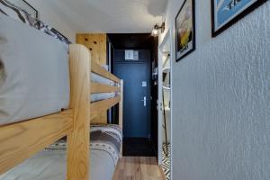 a hallway with two bunk beds in a room at Au 3ème ciel Tignes - Vue Lac & Montagnes - Proche pistes - Idéal 2 adultes + 2 enfants in Tignes