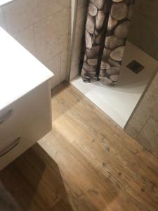 a bathroom with a white counter and a shower at L'auberge fleurie in Heilly