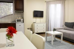 a living room with a couch and a table at Aqua&Luna Apartman in Gyula