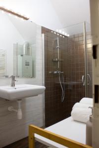 a bathroom with a sink and a shower at Aqua&Luna Apartman in Gyula