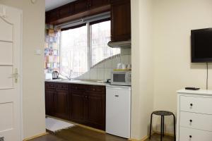 a kitchen with a sink and a microwave at Aqua&Luna Apartman in Gyula +12 photos