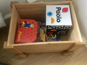 a wooden drawer filled with toys and a book at Ferienwohnung Keilbergblick in Kurort Oberwiesenthal