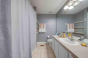 a bathroom with a sink and a shower curtain at The Lux At Lake Mary in Lake Mary +19 photos