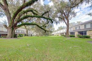 a group of trees in a yard next to a building at The Lux At Lake Mary in Lake Mary