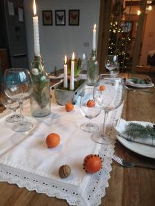 a table with candles and wine glasses on a table at Casa Domestic, Modern Guest House in Viştea de Sus