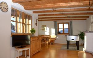 un salon avec une télévision et une salle à manger dans l'établissement Ferienwohnung Haus Wuhrbichl, à Marquartstein