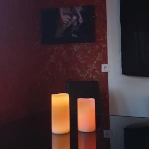 dos velas sentadas en una mesa en una habitación en Les Nuances de Mélis', en Crémieu