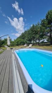 a swimming pool on a wooden deck at Kruszkanawierzbie in Kruszka
