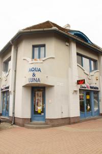 a building with a sign on the side of it at Aqua&Luna Apartman in Gyula