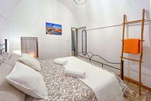 a bedroom with a large bed with white pillows at La Casetta di Zia Rosa in Monopoli