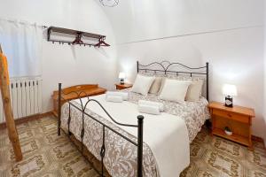a bedroom with a bed and two lamps and a window at La Casetta di Zia Rosa in Monopoli