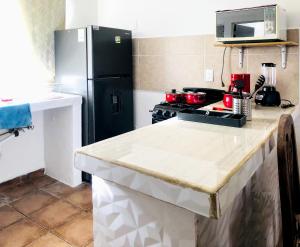 a kitchen with a black refrigerator and a stove at Casa Angeles in Nuevo Vallarta 