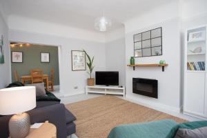 a living room with a couch and a tv at Foresters Cottage in Worthing