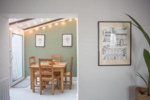a dining room with a wooden table and chairs at Foresters Cottage in Worthing