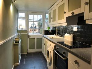 a kitchen with a sink and a dishwasher at Chapel Cottage Idylic Village Holiday Home in Box +16 photos