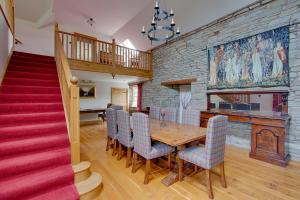 a dining room with a wooden table and chairs at Home Farm B&B - Sunflower Room in Forfar