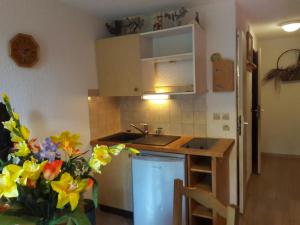 a kitchen with a sink and a counter with flowers at Combe Blanche 1309 in Manigod