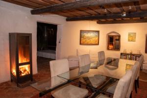 a living room with a glass table and a fireplace at WALD-LAND-HOF Schloss Rosenau in Schloss Rosenau